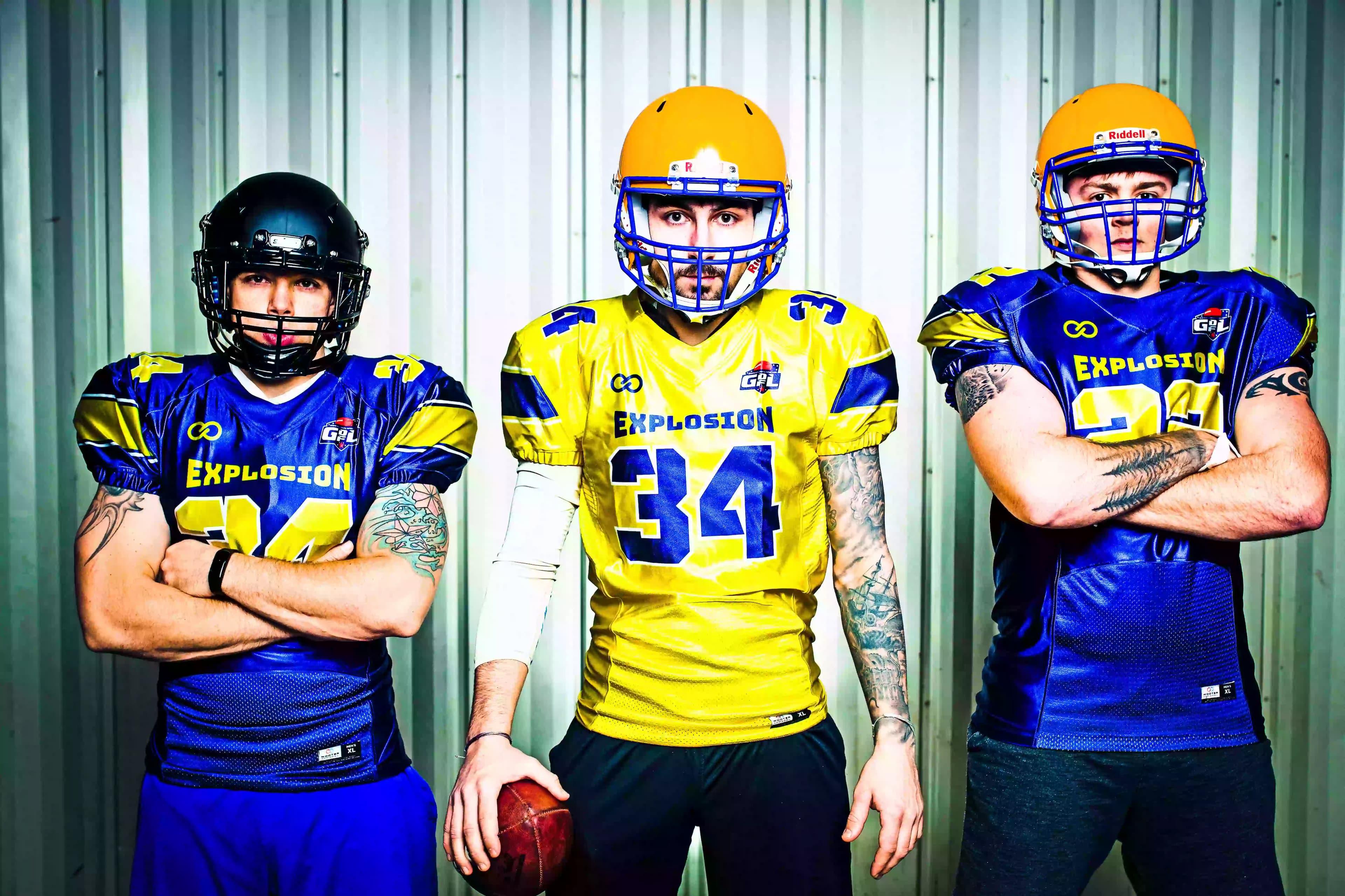 Custom American football jerseys in a royal blue and yellow sublimated design, featuring a stylish stripe on the sleeve.