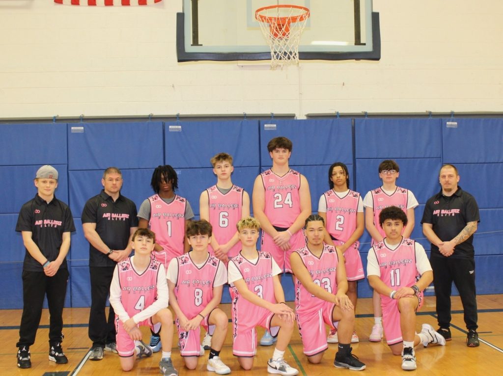 Youth basketball team wearing custom pink basketball uniforms produced through Wooter’s software-driven uniform platform